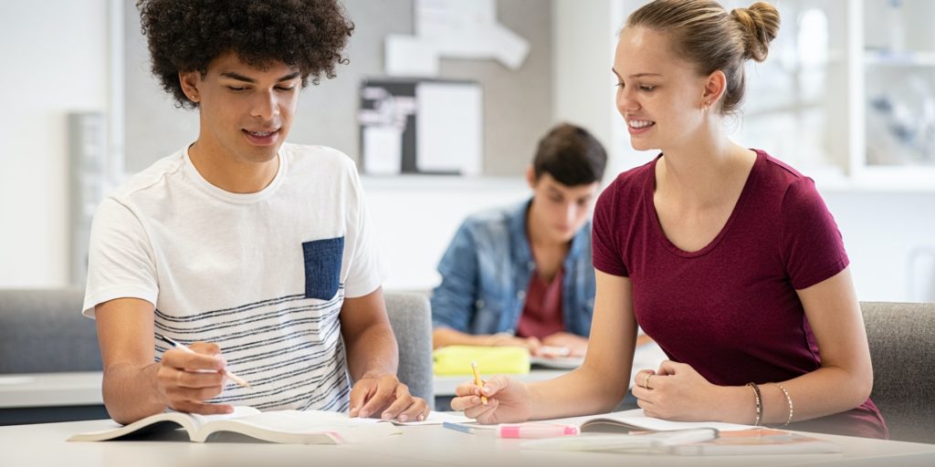 Teen students studying together at school