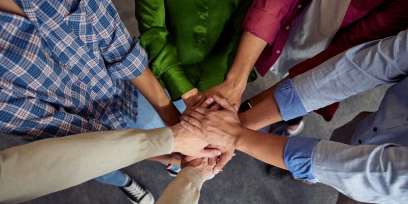 Top view of different ethnicity business people doing fists bump